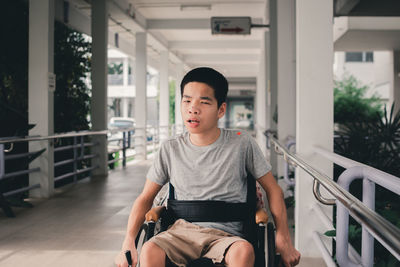 Portrait of boy sitting in park