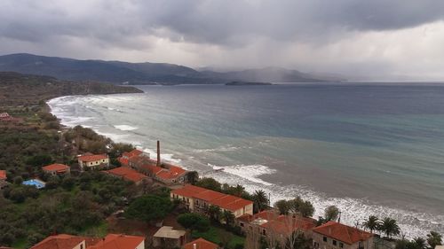 High angle view of townscape by sea against sky