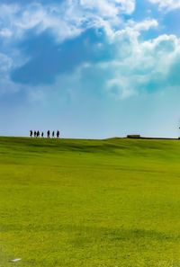 People on field against sky