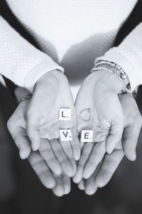 Close-up of hands with text