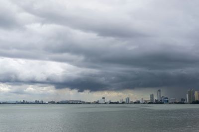 View of cityscape against cloudy sky