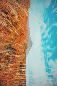 Digital composite image of mountain and sea against sky