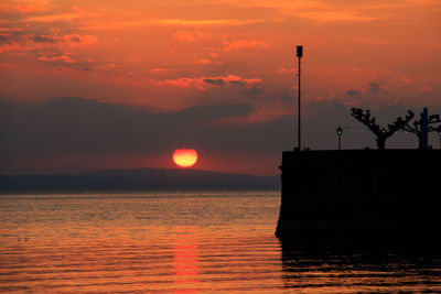 Scenic view of sea against orange sky