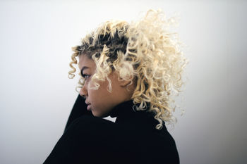 Close-up portrait of young woman against white background