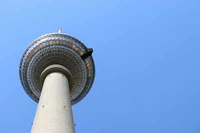 Low angle view of tower against blue sky