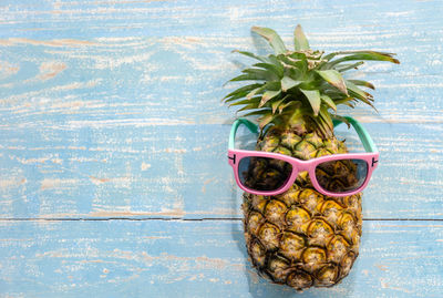 Close-up of fruits on table against swimming pool