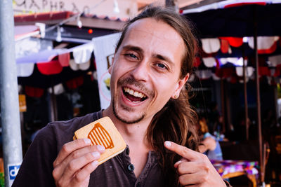 Portrait of cheerful man in city