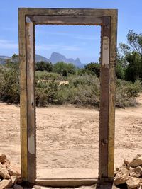 Wooden posts on field against sky