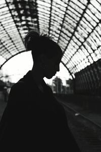 Close-up of silhouette person on roof against sky