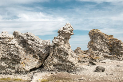 Low angle view of rock formation against sky