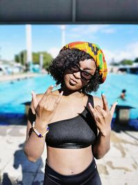 Mid adult woman standing by water