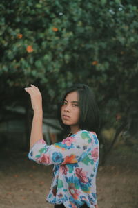 Portrait of beautiful woman standing on land