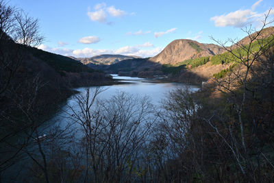 Scenic view of lake and mountains against sky