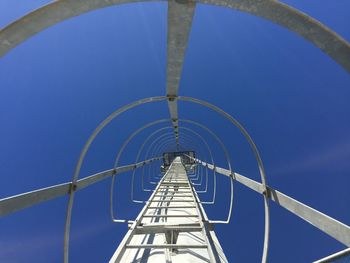 Low angle view of bridge against blue sky