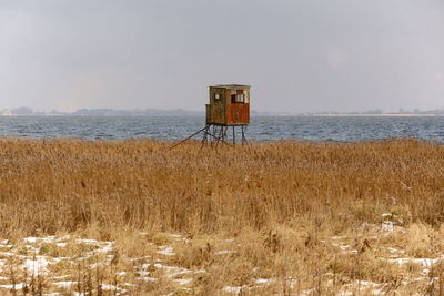 Lifeguard hut on beach against sky