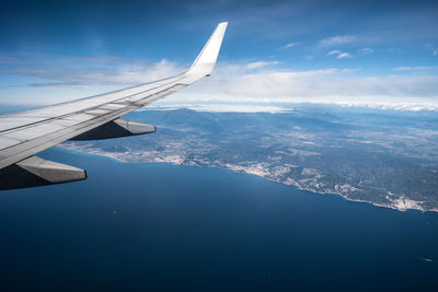 Aerial view of aircraft wing against sky