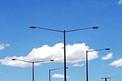 Low angle view of street light against blue sky