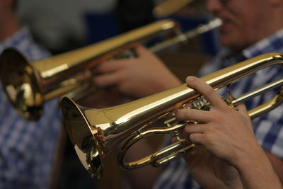 Close-up of men playing euphonium