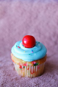 Close-up of cupcake on rug