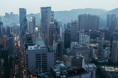 Aerial view of buildings in city against sky