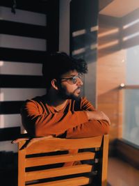 Side view of young man using mobile phone