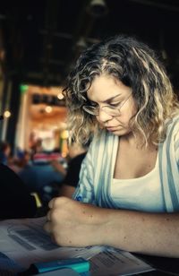 Portrait of young woman sitting on table