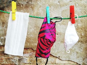 Clothes drying on clothesline against wall