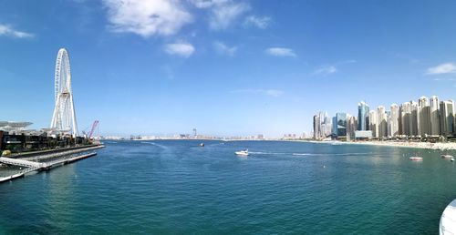 Panoramic view of sea and buildings against sky