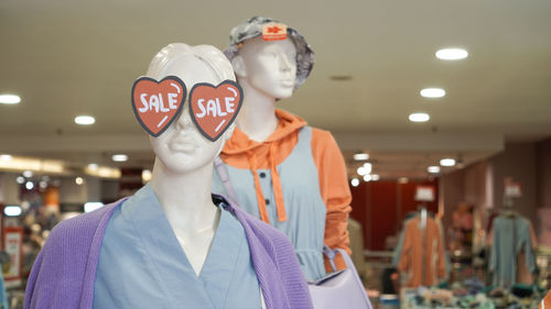 Sale and discount icon of fashion store. mannequin displayed at shopping mall.