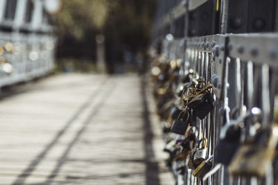 Close-up of bicycle by railing in city