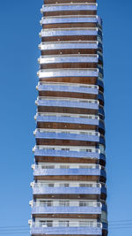 Low angle view of modern building against clear blue sky