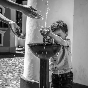 Side view of boy standing by water