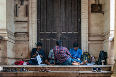 Group of people sitting outside building