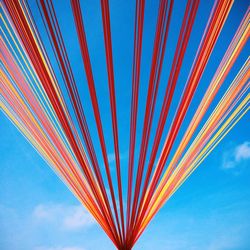 Low angle view of multi colored wall against blue sky