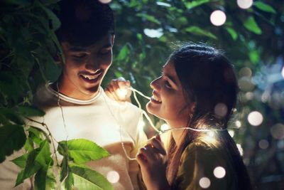 Portrait of young couple against plants