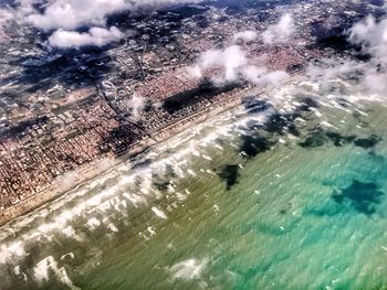 High angle view of sea and trees against sky