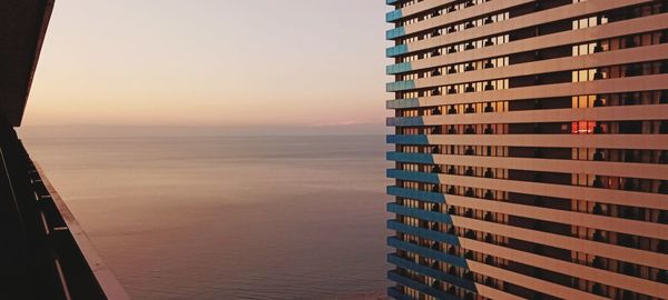 Hotel skyscraper orbi against the backdrop of  black sea and the sunset sky. view from the balcony