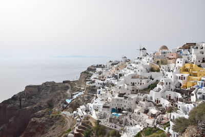 Townscape by sea against clear sky