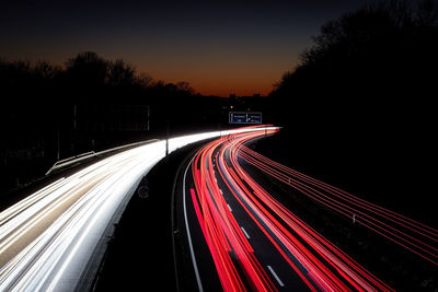 High angle view of light trails on highway at night