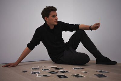 Young man looking away while sitting on stage