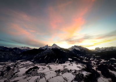 Scenic view of snowcapped mountains against sky during sunset