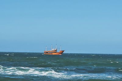 Boat in sea against clear sky