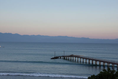 Scenic view of sea against clear sky during sunset
