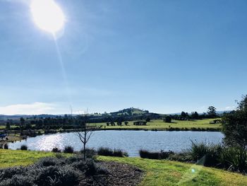Scenic view of lake against sky on sunny day