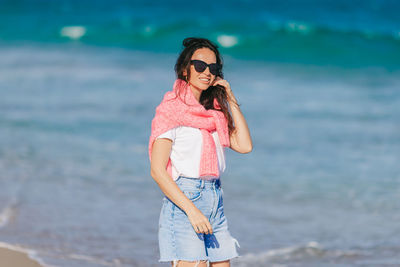 Young woman standing at beach