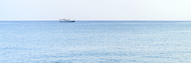 Sailboat sailing on sea against clear sky