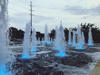 Scenic view of waterfall against sky during winter