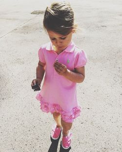 Girl standing on pink umbrella