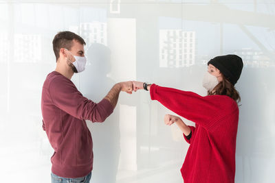 Side view of a young couple holding hands