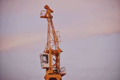 Low angle view of crane against sky